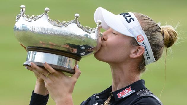Nelly Korda of the US kisses the winner's trophy at the Australian Open golf championship.(AFP)