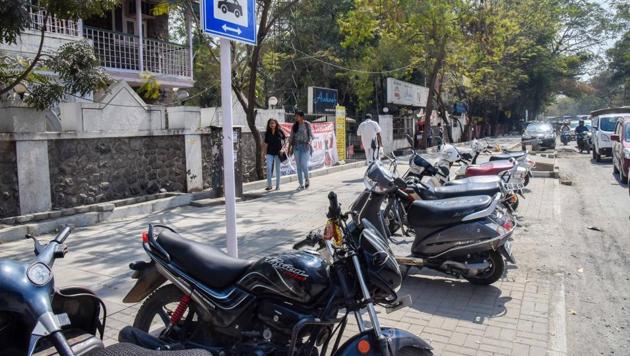 With poor police surveillance and legal action, the footpaths reserved for pedestrians along major city roads have become illegal parking spots for vehicles. (In pic) Vehicles parked on footpath at FC road.(HT/PHOTO)