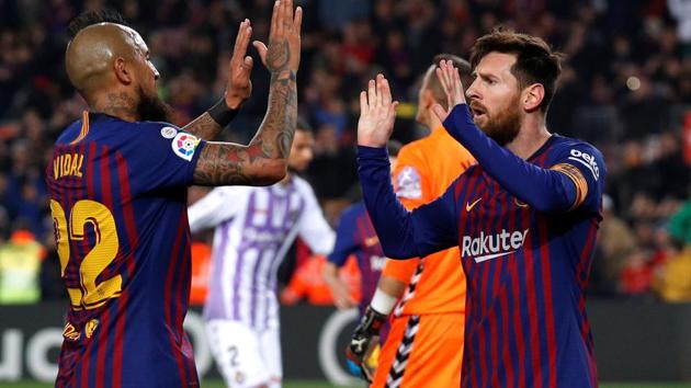 Barcelona's Lionel Messi celebrates scoring a goal with Arturo Vidal.(Reuters)