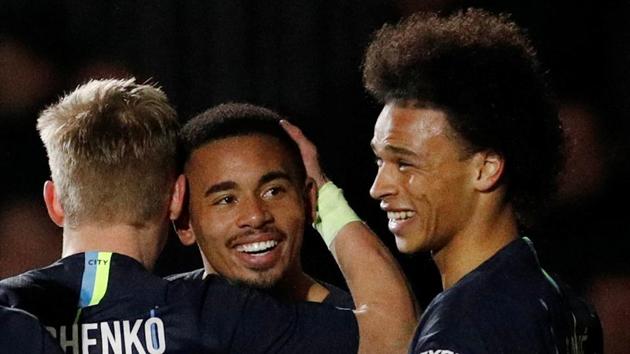 Manchester City's Leroy Sane celebrates with Gabriel Jesus and Oleksandr Zinchenko after scoring a goal against Newport.(Reuters)