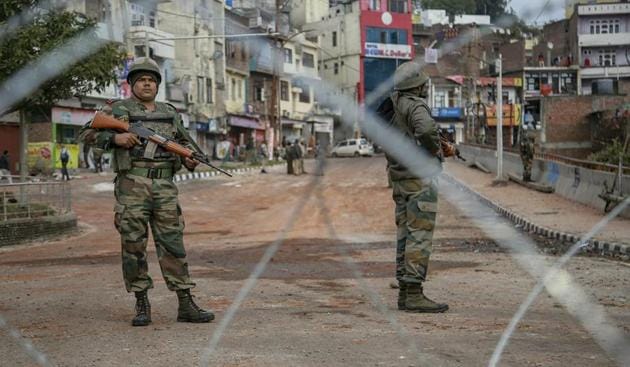 Army personnel stand guard at Gujjar Nagar area during a curfew, imposed on the third day after the clash between two communities over the protest against the Pulwama terror attack, in Jammu, Sunday, Feb. 17, 2019.(PTI photo)