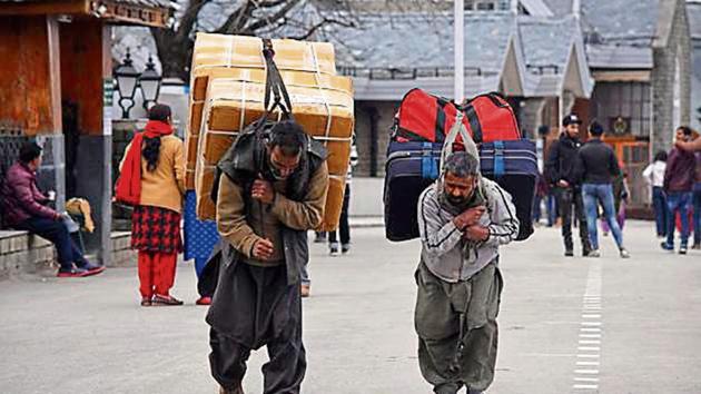 Kashmiri labourers carrying luggage on the Ridge, Shimla.(HT Photo)