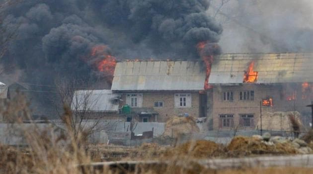 Smoke erupting from the house where terrorists had taken refuge in Pingilana village in south Kashmir’s Pulwama districton February 18.(Waseem Andrabi/ HT Photo)