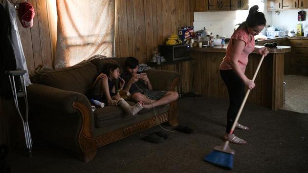 Carolina cleans as her siblings Bayron and Rachel play inside the family's trailer . Accompanied by minors, Orfa’s turn to apply came after a week. The family was transferred to a detention centre in Texas, and then released from custody to await future court appearances, suggesting authorities believed the family had demonstrated what the U.S. government calls “credible fear” of returning home. Trump has derided this practice, referring to it as “catch and release.” (Loren Elliott / REUTERS)