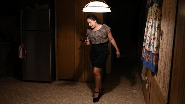Carolina prepares to leave the family's trailer for a party in Texico. In her native town San Pedro Sula in Honduras, the seventeen-year-old’s school friend was raped by gang members, and Caroline was told that “she was next.” She could never go out in Honduras, unlike now. (Loren Elliott / REUTERS)