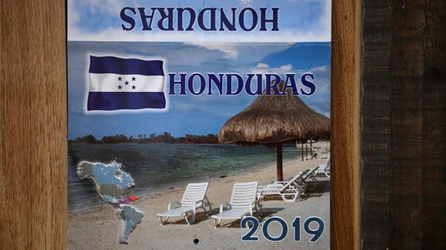 A Honduras calendar is fixed to a wall inside the family's trailer in Texico. “I want to give the children what I can, have them go to school,” said Orfa. “They are the important ones. It is not easy here, but maybe the children can study and achieve something.” (Loren Elliott / REUTERS)