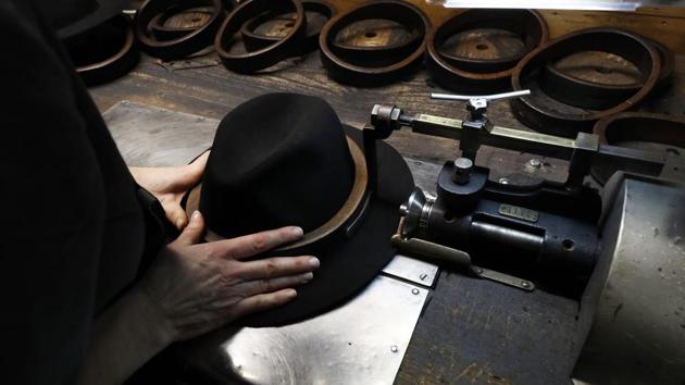 A man holds a hat inside the Borsalino hat factory. To relaunch Borsalino, Camperio has brought in a team of fashion experts, including former Gucci CEO Giacomo Santucci. The expansion plan foresees selling more in the United States and Asia and developing new collections to appeal to younger generations and to women, two key growth markets. (Antonio Calanni / AP Photo) A man holds a hat inside the Borsalino hat factory. To relaunch Borsalino, Camperio has brought in a team of fashion experts, including former Gucci CEO Giacomo Santucci. The expansion plan foresees selling more in the United States and Asia and developing new collections to appeal to younger generations and to women, two key growth markets. (Antonio Calanni / AP Photo)
