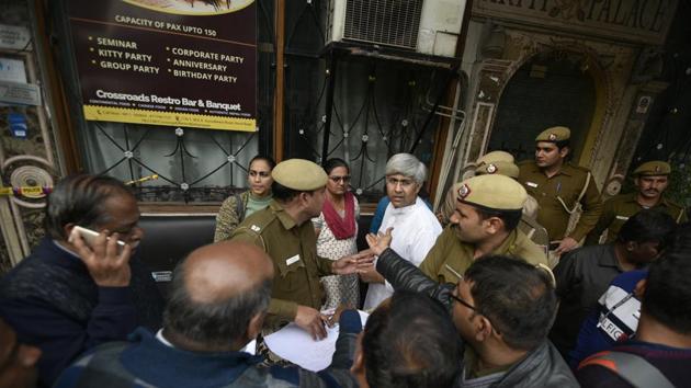 Hotel guests and police personnel outside Hotel Arpit Palace where a fire killed 17 people, Feb 13, 2019.(Biplov Bhuyan/HT Photo)