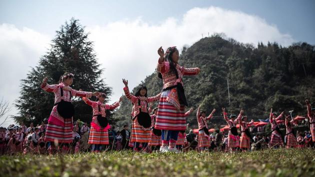 Girls participate in the annual flower festival or 'Tiaohuajie' in the village of Longjia in China's Guizhou province. The festival was held on Thursday, February 14, the 10th day of the Lunar New Year. (Fred Dufour / AFP)