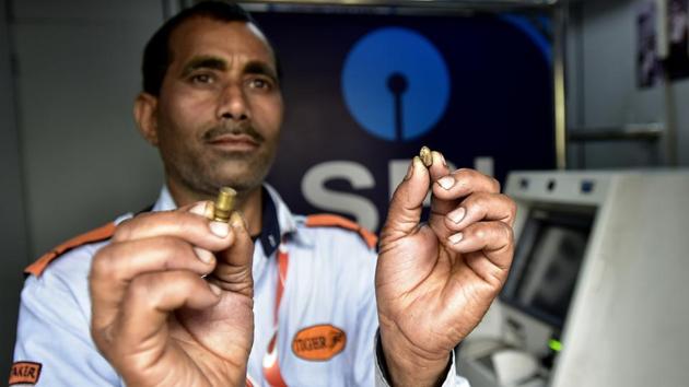 SBI ATM security guard shows bullets that were fired outside the ATM at Kendriya Vihar 2 society in Sector 82, in Noida, on Tuesday, February 19, 2019.(Virendra Singh Gosain/ HT Photo) SBI ATM security guard shows bullets that were fired outside the ATM at Kendriya Vihar 2 society in Sector 82, in Noida, on Tuesday, February 19, 2019.(Virendra Singh Gosain/ HT Photo)