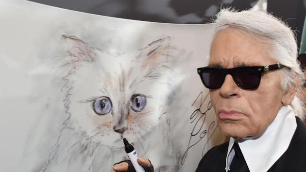 Karl Lagerfeld poses next to a painting of his cat Choupette during the inauguration of the show Corsa Karl and Choupette at the Palazzo Italia in Berlin.(AFP) Karl Lagerfeld poses next to a painting of his cat Choupette during the inauguration of the show Corsa Karl and Choupette at the Palazzo Italia in Berlin.(AFP)