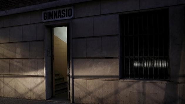 The headlights of a passing car in Madrid illuminate the entrance to the gym of the school where Fernando Garcia-Salmones says he was raped by a priest almost 44 years ago. In Spain, historically a fervently Catholic country, activists say thousands of cases had likely been silenced and many could emerge now as the debate opens up. (Susana Vera / REUTERS)