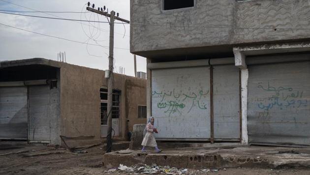 A girl walks in an area recently retaken by the SDF from Islamic State militants in Hajin. At least 62 people have died in recent weeks, mainly from exhaustion and malnutrition, after making their way out of militant-held territory, the International Rescue Committee said. Spokesman Paul Donohoe said two-thirds were children under the age of one. He said they either died along the way or soon after arriving at a camp for the displaced. (Felipe Dana / AP)