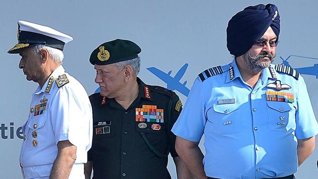 (L-R) Navy chief Admiral Sunil Lanba, Army chief General Bipin Rawat and Air Force chief Marshal Birender Singh Dhanoa participate in the opening ceremony on the inaugural day of the show. (Manjunath Kiran / AFP)
