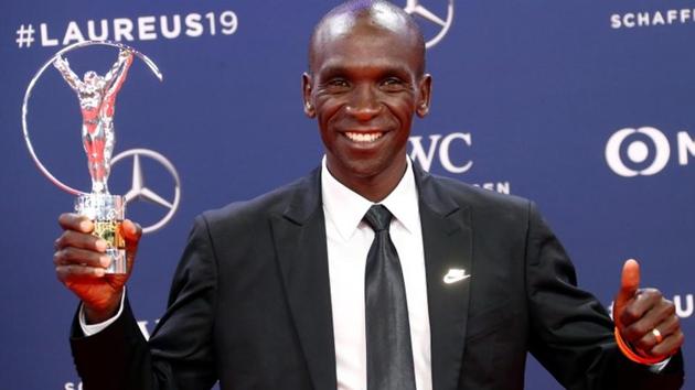 Eliud Kipchoge poses after winning the Exceptional Achievement Award at the Laureus World Sports Awards.(REUTERS)