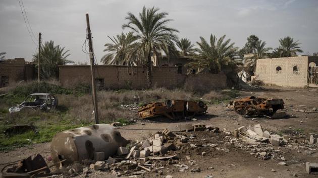 Damaged cars sit in an area recently retaken by SDF from Islamic State militants in Susah. The SDF and the U.S.-led coalition have been fighting IS in the surrounding region since September. In recent years, they and other forces have steadily driven IS from nearly all the territory it once controlled, in battles that have killed tens of thousands of people and left entire towns and neighbourhoods in ruins. (Felipe Dana / AP)