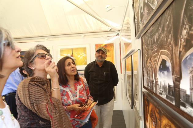 Visitors at HT Imagine Fest 2018 enthral themselves in discussions over artworks on display.