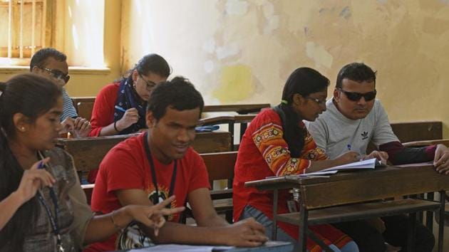Visually challenged students, with their writers in examination hall  at SP college as HSC exams commence in the state. (Pratham Gokhale/HT Photo) 