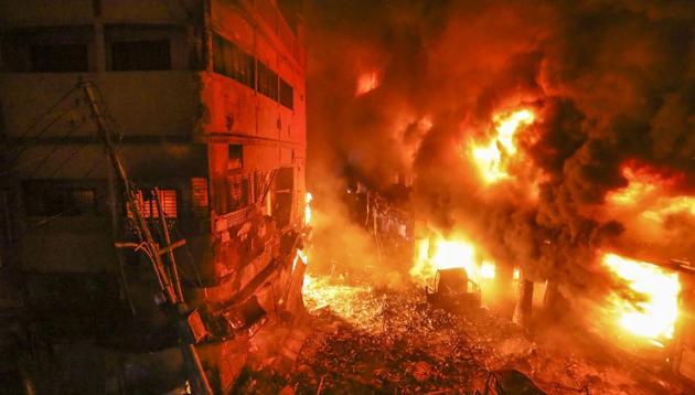 Flames rise from a fire in a densely packed shopping area in Dhaka, Bangladesh on Wednesday. The fire that killed at least 67 people in the oldest part of the Bangladeshi capital shows the lapses in public safety that still plague the South Asian country despite its rapid economic growth. (Zabed Hasnain Chowdhury / AP)