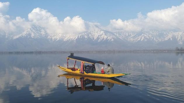 A man rows his boat on the waters of Dal Lake with the snow-covered mountains in the backdrop on a sunny day in the outskirts of Srinagar, Jammu and Kashmir. (Waseem Andrabi / HT Photo) A man rows his boat on the waters of Dal Lake with the snow-covered mountains in the backdrop on a sunny day in the outskirts of Srinagar, Jammu and Kashmir. (Waseem Andrabi / HT Photo)