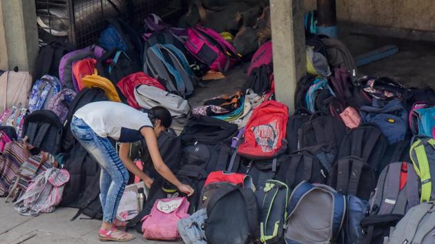A student is seen keeping her bag outside the exam centre before entering.  (Sanket Wankhade/HT PHOTO) 