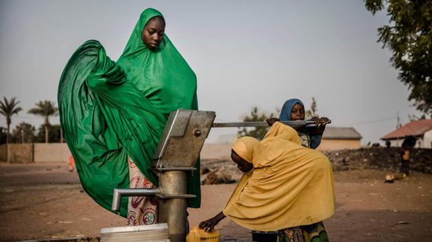 Camp dwellers pump water from a well at Malkohi refugee camp in Jimeta, Adamawa State, Nigeria. About 2,800 people have been displaced to the camp in Malkohi village from the Borno state town of Gwoza, which the insurgents sacked in 2014. More than 27,000 people have been killed since the Boko Haram conflict began in 2009 and some 1.8 million others are still displaced. (Luis Tato / AFP)