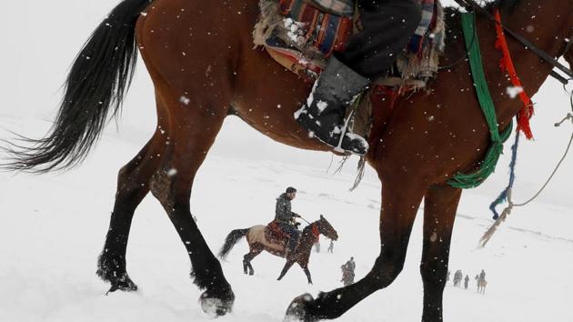 Afghan men ride horses on the snow-covered ground on the outskirts of Kabul, Afghanistan. (Omar Sobhani / REUTERS)