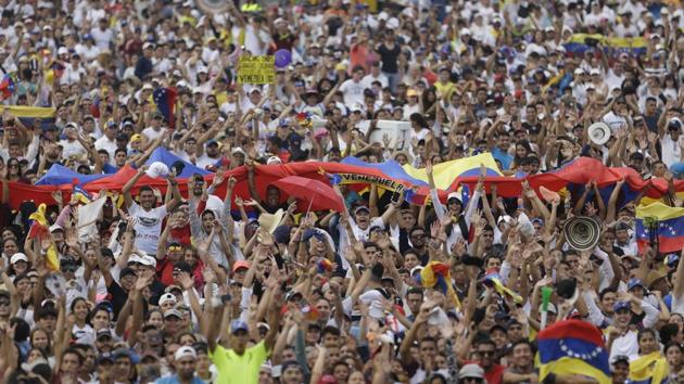 People begin to fill the Venezuela Aid Live concert on the outskirts of Cucuta, Colombia.The aid push comes on the heels of this giant concert organized by British billionaire Richard Branson aimed at pressuring Maduro to accept the aid. Tens of thousands of Venezuelans gathered in a field to hear pop stars like Juanes sing beneath a scorching sun. Guaido made a surprise appearance toward the end. (Fernando Vergara / AP)