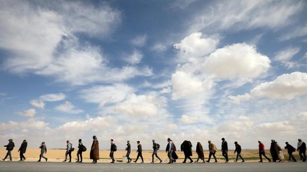 People walk during a march from the city of Aqaba south of the capital, demanding more employment opportunities, on the highway near Amman, Jordan. (Muhammad Hamed / REUTERS)