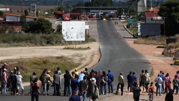 People at the border between Venezuela and Brazil. International leaders including UN Secretary-General Antonio Guterres are appealing for the sides to avoid violence as the opposition tries to get food and medical supplies across bridges that Venezuelan authorities ordered closed Friday night. In previous waves of unrest, citizens have been tear-gassed and even killed during protests. (Ricardo Moraes / REUTERS)