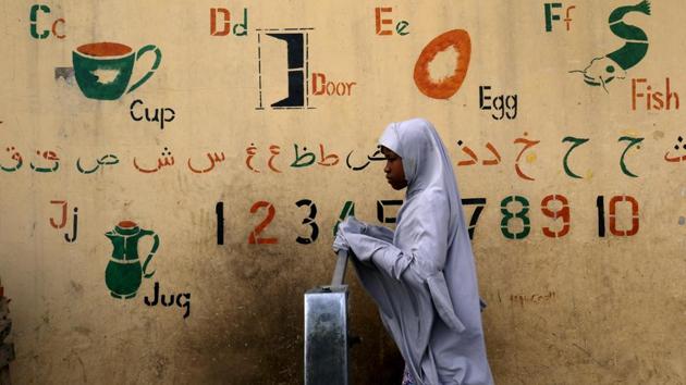 A girl draws water from a fountain a day after the postponement of the presidential election in Kano, Nigeria. (Luc Gnago / REUTERS)