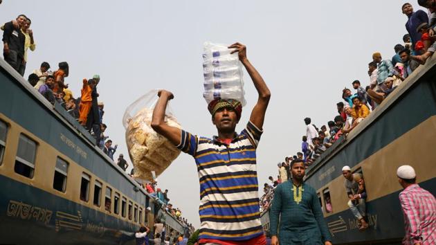 A man sells water and dry food at a rail station during the final prayer meeting of “Bishwa Ijtema”, the world congregation of Muslims, on the banks of the Turag river in Tongi near Dhaka, Bangladesh. (Mohammad Ponir Hossain / REUTERS)