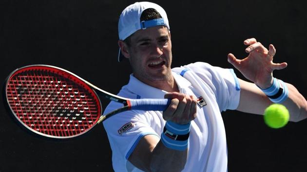 John Isner of the US hits a return against Reilly Opelka of the US.(AFP)