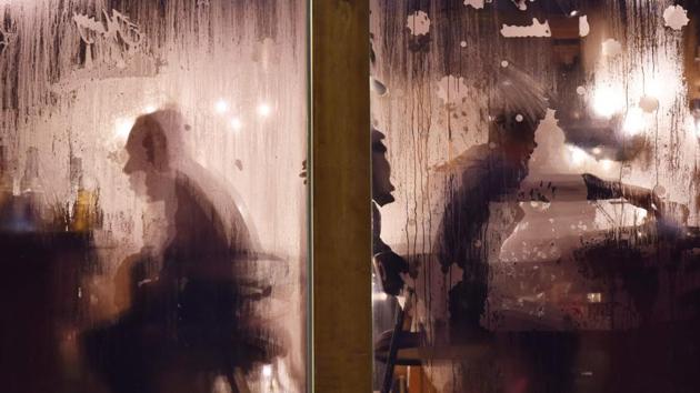 Diners are seen through the steamed-up windows of a hotpot restaurant in Beijing, China. (Greg Baker / AFP)