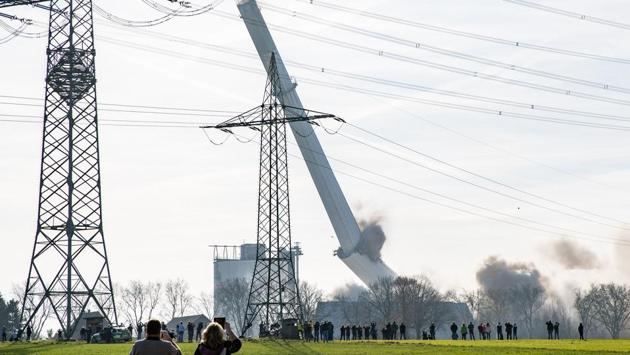 People watch the targeted detonation of the chimney of former coal-fired power station Gustav Knepper near Castrop-Rauxel, Germany. (Marcel Kusch / dpa / AFP)