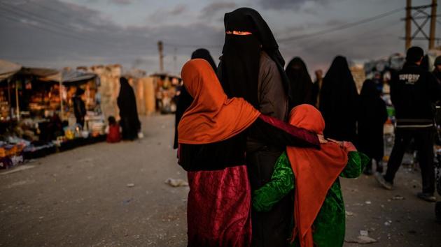 A veiled woman looks back at al-Hol camp in al-Hasakeh governorate in northeastern Syria. (Bulent Kilic / AFP)