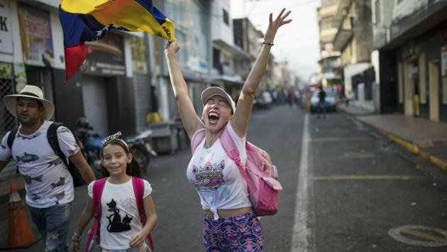 A woman shouts “Freedom!” as she walks with her family towards the Venezuela Aid Live concert on the Colombian side of the border. The opposition is planning to hold three simultaneous aid pushes on Saturday. Aside from the events in Colombia, they also hope to get humanitarian assistance delivered by sea and through Venezuela’s remote border with Brazil. (Rodrigo Abd / AP)