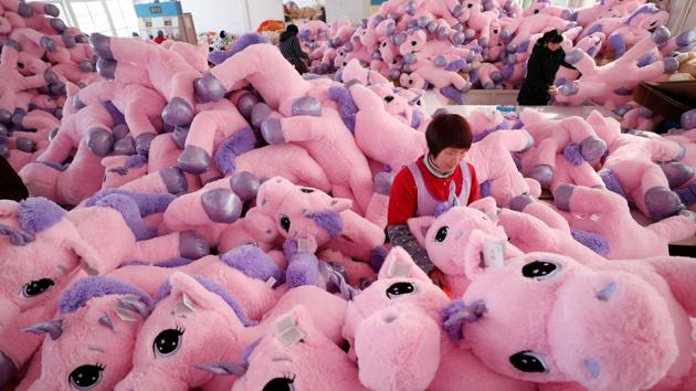 Women work on unicorn stuffed toys for export at a workshop in Lianyungang, Jiangsu province, China. (REUTERS)