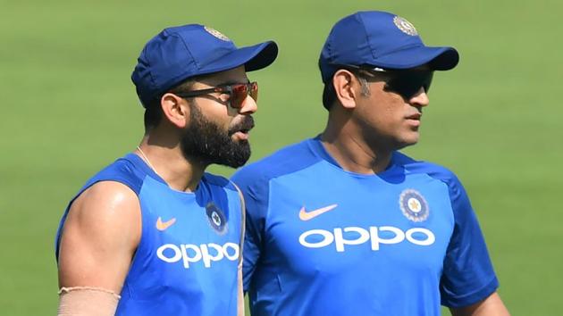 Indian cricket team's captain Virat Kohli (L) with Mahendra Singh Dhoni attend a training session.(AFP)