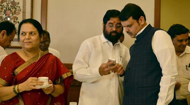 Maharashtra CM Devendra Fadnavis with PWD minister Eknath Shinde and Shiv Sena leader Neelam Gorhe at the customary tea party held on the eve of the budget session of the state Assembly, at Malabar Hill on Sunday. (Bhushan Koyande/HT Photo) Maharashtra CM Devendra Fadnavis with PWD minister Eknath Shinde and Shiv Sena leader Neelam Gorhe at the customary tea party held on the eve of the budget session of the state Assembly, at Malabar Hill on Sunday. (Bhushan Koyande/HT Photo)