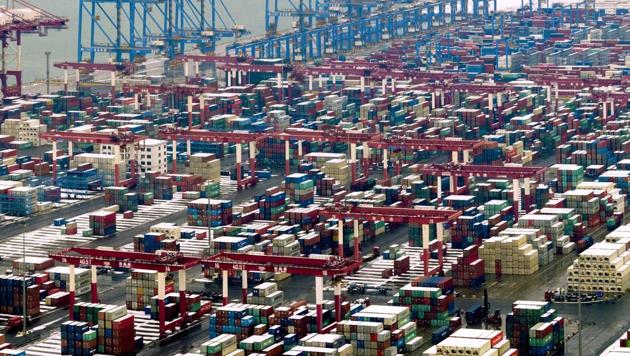 Trucks move around containers stored at a port in Qingdao in east China's Shandong province. (AP Photo) Trucks move around containers stored at a port in Qingdao in east China's Shandong province. (AP Photo)