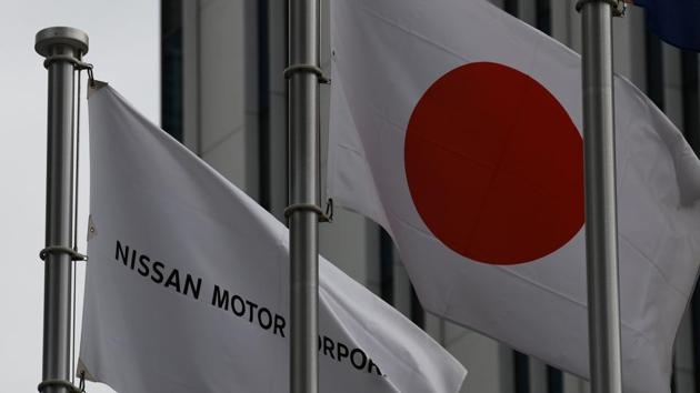 The Nissan flag is hosted beside Japan's national flag in front of the headquarters of Japanese auto maker Nissan in Yokohama, suburban Tokyo on February 12.(AFP File Photo)