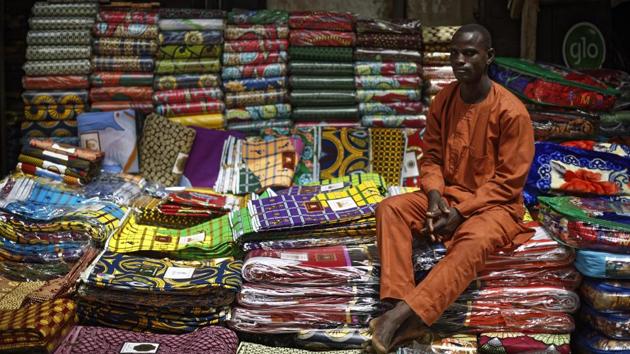Ibrahim’s colleague Ismailu acknowledged that “money has gone down” in their industry, lamenting that “too much technology” is used by upstart competitors. For those seeking something flashier, a separate area dyes finer cloth from packages stamped “Made in Germany” or Britain, at prices of 25,000 naira (USD 69), purchased by Nigeria’s so-called “big men.” (Ben Curtis / AP)