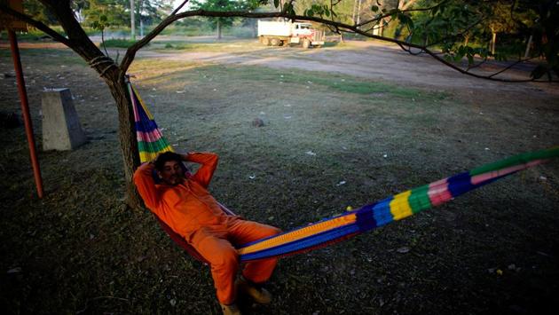 A Pemex worker rests in a hammock in an area in which the new oil refinery is planned to be built. Oil industry environmental regulator ASEA in January ruled that the contractor that deforested the land did not have the correct permits to do so. The body levied a fine of about $700,000. Work can only go ahead once a full environmental impact assessment is done and approved. (Alexandre Meneghini / REUTERS) A Pemex worker rests in a hammock in an area in which the new oil refinery is planned to be built. Oil industry environmental regulator ASEA in January ruled that the contractor that deforested the land did not have the correct permits to do so. The body levied a fine of about $700,000. Work can only go ahead once a full environmental impact assessment is done and approved. (Alexandre Meneghini / REUTERS)