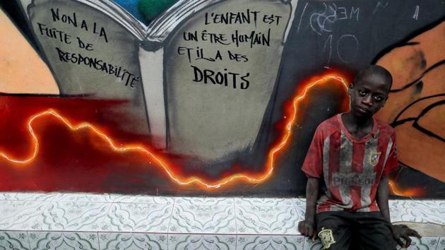 A talibe at Maison de la Gare. The writing on the wall reads: “No to running away from responsibility, the child is a human being and has rights.” The government has set up a free hotline to report cases of child abuse. “These are our children, and we are trying to involve everyone in protecting them,” said Alioune Sarr, head of Child Protection in the Senegalese government. (Zohra Bensemra / REUTERS)
