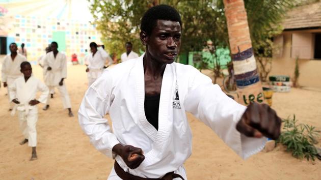 Abdel Rahman, 20, a former talibe, who became a karate coach at Maison de la Gare. “I have myself experienced the pain of being sent to the streets to beg. Karate helped me a lot, now it’s my turn to help others get out,” Rahman said. “I’m one of them and they trust me. I urge them to participate in a local championship. It’s one of the ways to reintegrate into society.” (Zohra Bensemra / REUTERS)