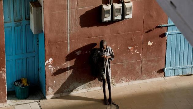 A Quran student, called a talibe, eats as he begs in front of a hotel in Saint-Louis, Senegal. An eight-year-old boy fled his Quranic school in Saint-Louis, Senegal this month after he said a teacher threatened to beat him for not earning enough money begging on the street. Hours later, alone in the corner of a low-lit bus station, he was raped by a teenager. (Zohra Bensemra / REUTERS)