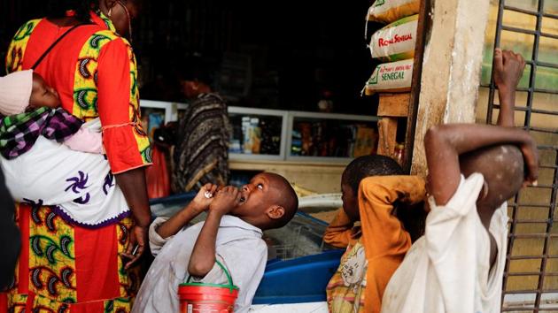 Amadou, 7, looks at a woman as he begs outside a shop. The ill-treatment of talibes was a largely taboo subject, but awareness campaigns have slowly provoked debate. President Macky Sall in 2016 launched a plan ordering the removal of children from the streets and said those who force them to beg would be jailed. About 300 hundred were helped by the program in 2018, government figures show. (Zohra Bensemra / REUTERS)