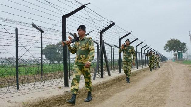 BSF jawans patrolling along the Indo-Pak international border in Amritsar on Wednesday.(HT Photo)