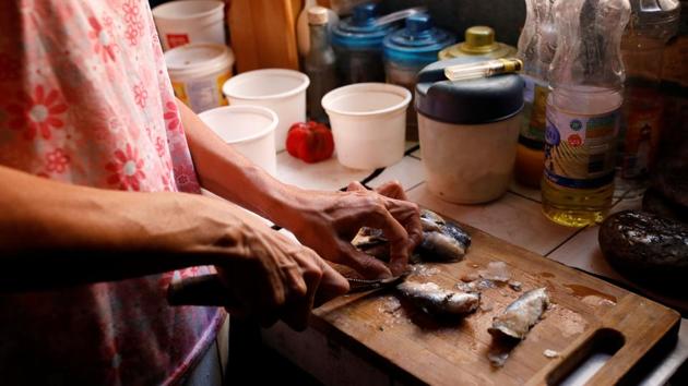 Yaneidi Guzman prepares sardines in her kitchen. Sometimes she wakes up not knowing what she will feed her family that day. Mostly they eat rice, lentils and cassava. While Guzman says she would welcome the aid, she is concerned the one-off shipment would be a drop in an ocean given Venezuelans’ needs. “You don’t only eat once,” she said. (Carlos Garcia Rawlins / REUTERS) Yaneidi Guzman prepares sardines in her kitchen. Sometimes she wakes up not knowing what she will feed her family that day. Mostly they eat rice, lentils and cassava. While Guzman says she would welcome the aid, she is concerned the one-off shipment would be a drop in an ocean given Venezuelans’ needs. “You don’t only eat once,” she said. (Carlos Garcia Rawlins / REUTERS)